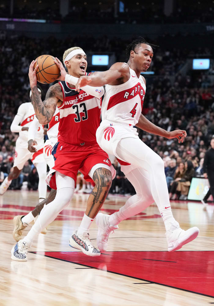 Washington Wizards forward Kyle Kuzma (33) battles for the ball with Toronto Raptors forward Scottie Barnes (4) during the fourth quarter at Scotiabank Arena.